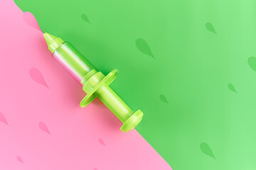 green toy slang in pink and green background with drops