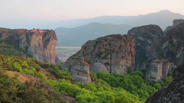 Mornig view of famous Eastern Orthodox monasteries listed as a World Heritage site, built on top of rock pillars. Summer scene of Kalabaka location, Greece, Europe. Full HD video (High Definition).