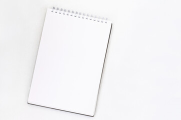 creative process. blank sheet of spiral notebook, cup of coffee on a white background.