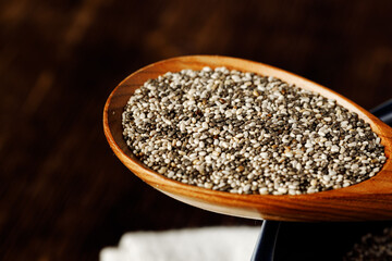 Chia seeds in a wooden spoon close up