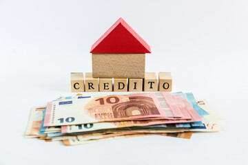 Word "loan" written with wooden blocks on white background "credito" means "loan" in spanish