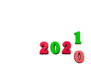 Changes the year 2020 to 2021. Red and green wooden numbers on white background. New year and holiday concept, Christmas colors. Blank for design, space for text