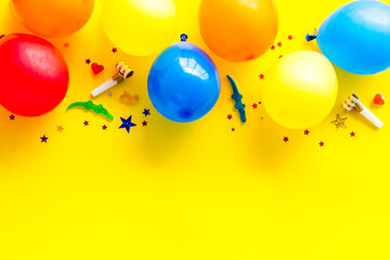 Flat lay with ballons - party concept - on yellow background top-down copy space