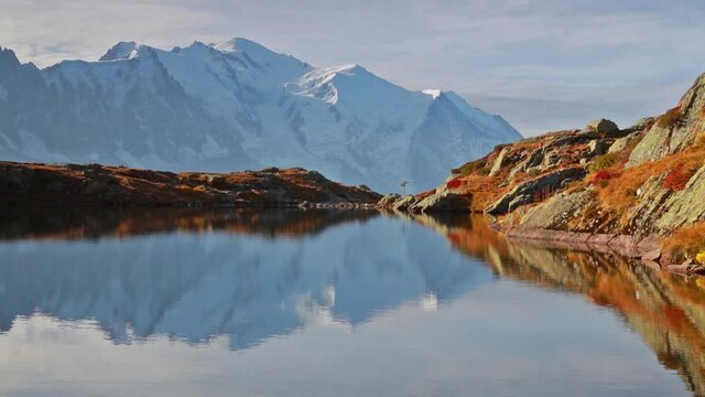 View of Cheserys lake with Mount Blanc on background, Chamonix location. Fantastic  autumn sunrise in Vallon de Berard Nature Preserve, Alps, France, Europe. Full HD video (High Definition).
