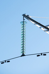 Electric glass insulator on a pole. Closeup view