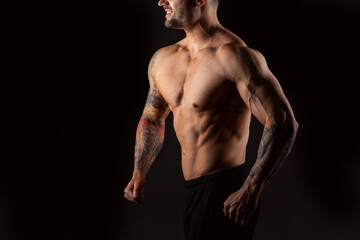 Fototapeta na wymiar Close up body strong man. Bodybuilder on black background.
