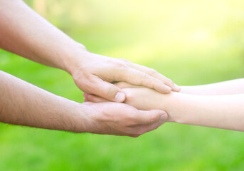 Father male hands holding child hands