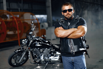 Portrait of motorbike rider in black leather outfit