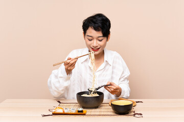Young Asian girl in a table with bowl of noodles and sushi