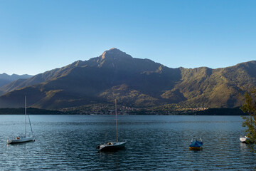 Fototapeta na wymiar placid lake with sailing boat and blue sky