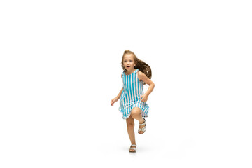 Happy child, little and emotional caucasian girl jumping and running isolated on white background. Looks happy, cheerful, sincere. Copyspace for ad. Childhood, education, happiness concept.