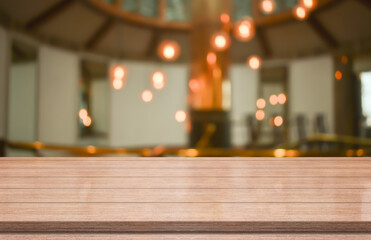 Empty wooden table top on blur coffee shop background