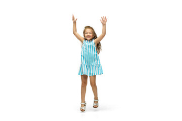 Happy child, little and emotional caucasian girl jumping and running isolated on white background. Looks happy, cheerful, sincere. Copyspace for ad. Childhood, education, happiness concept.