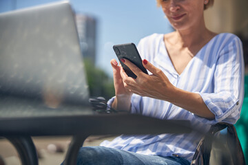 Woman reading a text message on her smartphone