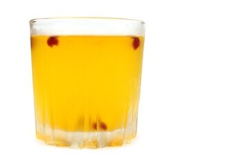 yellow iced tea with berries in a steamed glass isolated on white
