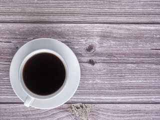 Top view of a white coffe cup on old wooden table