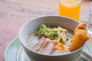 Asian rice porridge with Chinese donut and boiled egg for breakfast