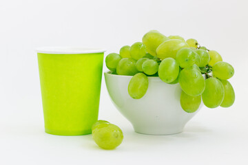 green grapes in a plate on a white background