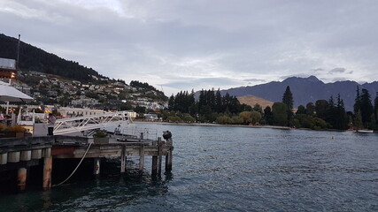 Lake Wakatipu with mountain view, town view, harbor view port view, pier view, sunset and clouds in summer, located in the southwest corner of the Otago region, in the South Island of New Zealand
