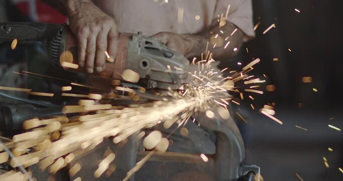Glowing flow of sparks from grinder. 4K.