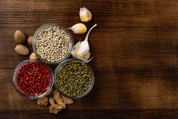 Bowls with assorted spices on dark background