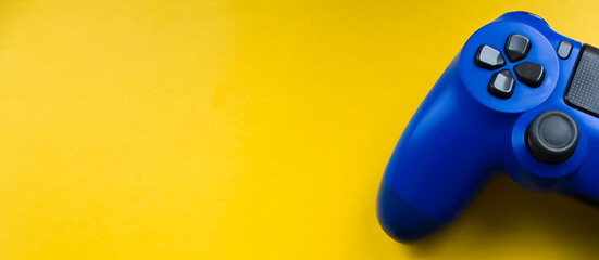 Blue gamepad on a bright yellow background. Banner
