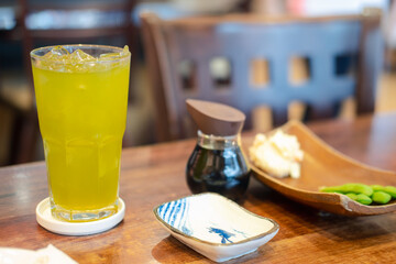 Iced green tea on wood table at Japan restaurant