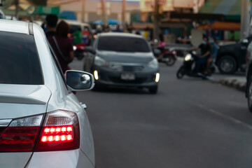 Blurred of car on the road with open light brake in city.