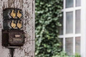 Electric connection on old industry facade