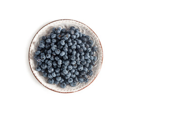 Blueberries on a white plate on a white background. View from above. Copy space.