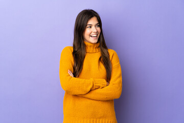Fototapeta premium Teenager Brazilian girl over isolated purple background happy and smiling