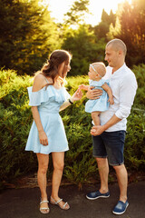 Obraz premium Loving overjoyed parents hold their adorable daughter