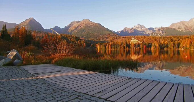 Wonderful autumn view of Strbske pleso lake. Romantic morning scene of High Tatras National Park, Slovakia, Europe. Beauty of nature concept background. 4K video (Ultra High Definition).