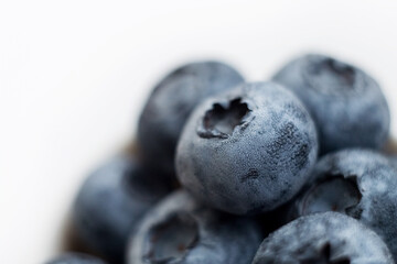 Fresh blueberry close-up isolated on a white background. Shallow depth of field. Healthy and dietary food concept. Fresh berries.