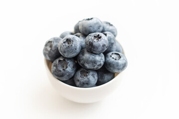 Fresh blueberry close-up isolated on a white background. Shallow depth of field. Healthy and dietary food concept. Fresh berries.
