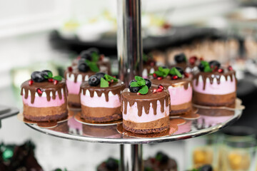 Three tier tray with cakes on the banquet table. Holidays and events.