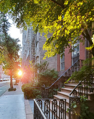 New York City - Sunlight shines on the buildings along a quiet street in the Greenwich Village...