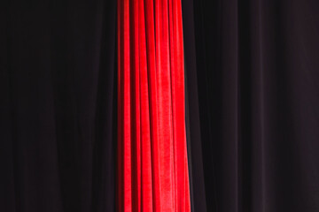 Black and red draped curtain hanging close-up