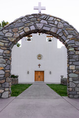 Strone arch leading to the entrance doors of the St. Francis de Paula Franciscan Mission founded in 1865 in Tularosa, New Mexico.