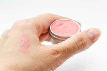 Swatch on a female hand of pink lipstick