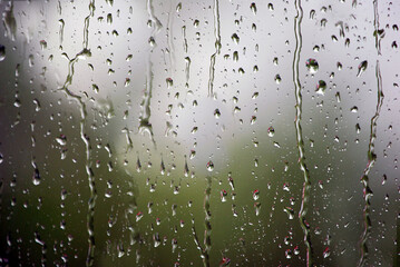 Raindrops running down the glass of a car window