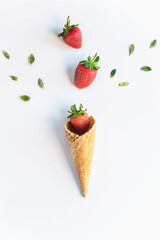 Fresh strawberries with an ice-cream cone on a white kitchen counter, isolated, above vantage point photography, colors