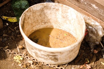 Dirty bucket with mud in gypsy village