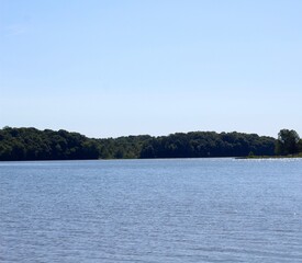 The calmness of the lake water in the countryside.