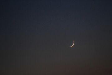 crescent moon over blue sky