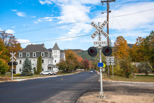 Railroad crossing along a street in a mountain town on a clear autumn day. NH, USA.