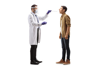 Doctor with face shield taking a cotton swab test from a young man