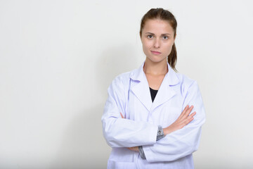 Portrait of young beautiful woman doctor against white background