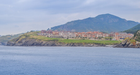 Village surrounded by mountains at the seashore