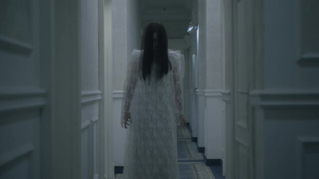 Terrible zombie bride walking long hallway possessed by evil spirit horror night